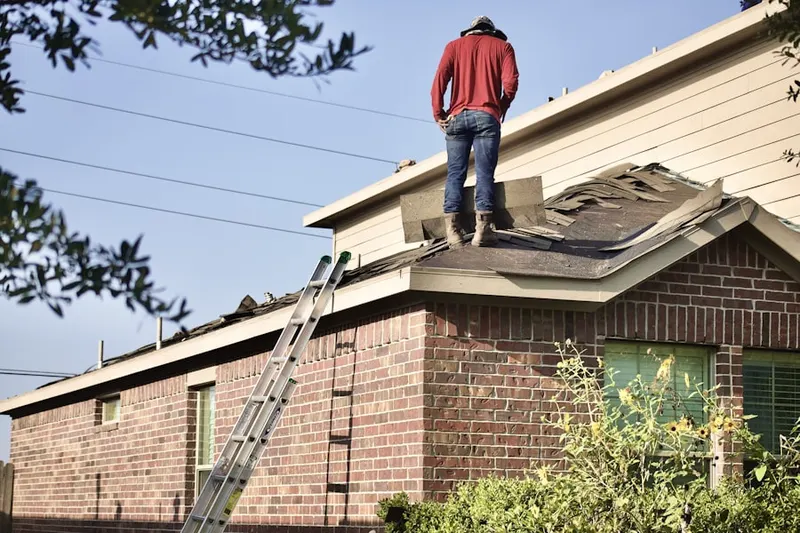 Professional roofer working on a residential roof in Allegan